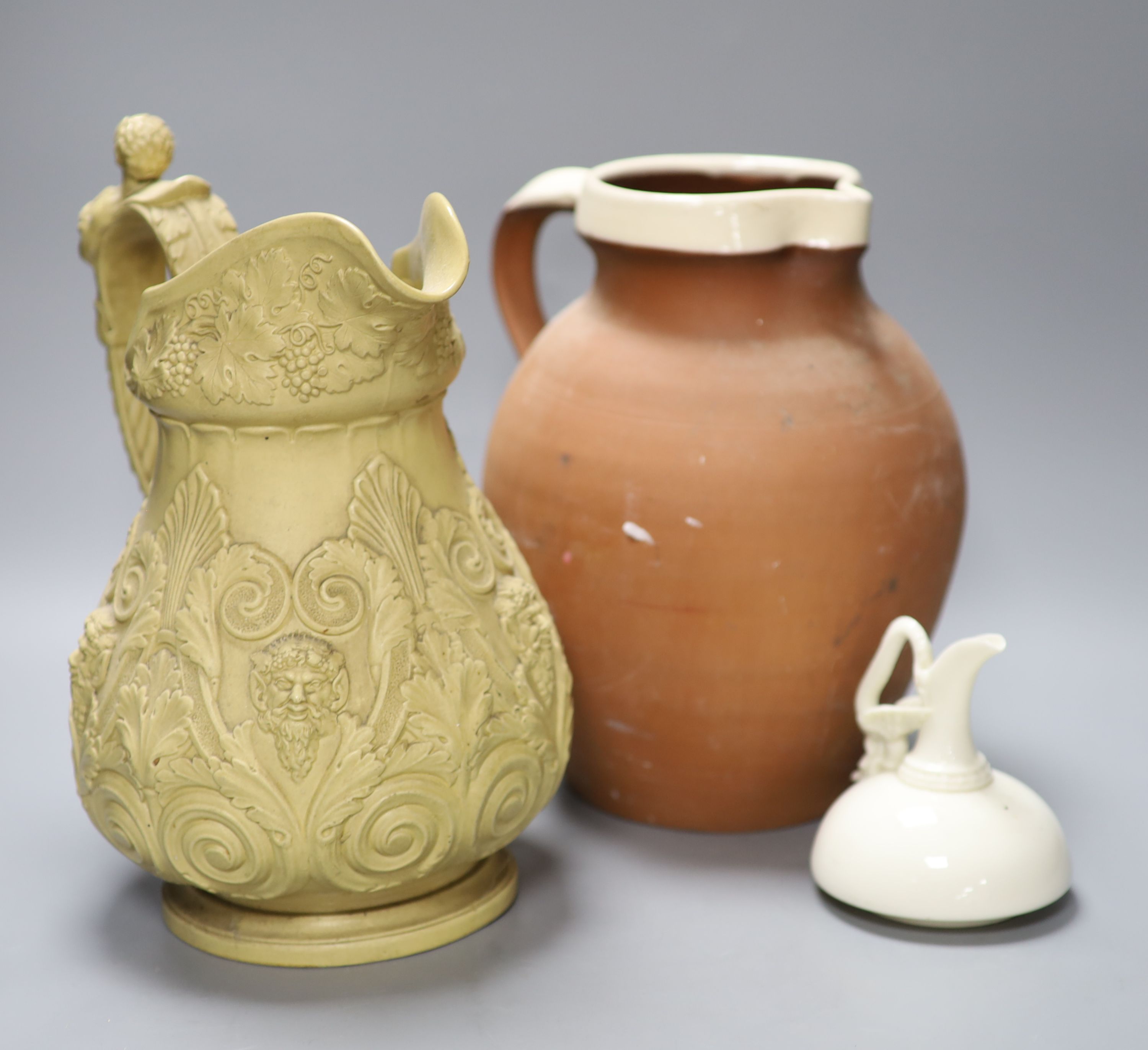 An ornate 19th century jug, another and a cream glazed Worcester jug, tallest 29cm